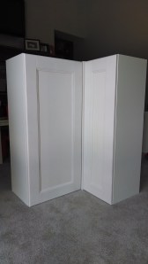 In order to space the doors correctly so that they would open without interference, Honest Husband placed a single cover panel between the two cabinets to give them clearance.